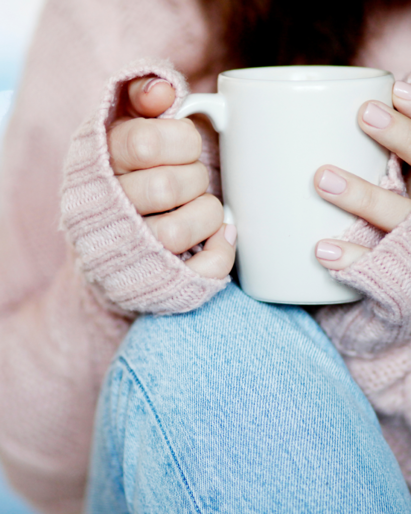 close-up photo of woman's hands holding a mug